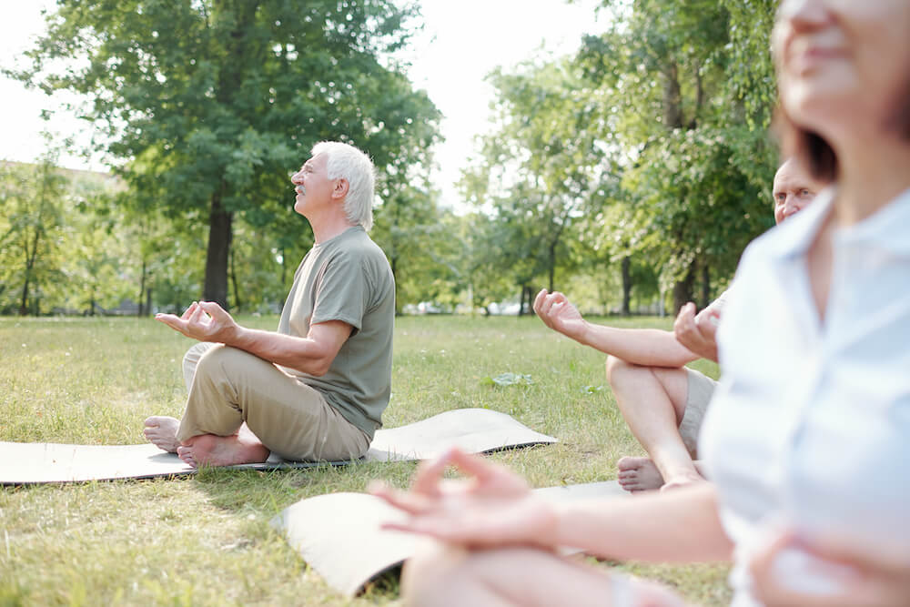 Seniors meditating at park