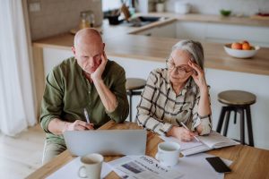 stressed senior couple calculate expenses